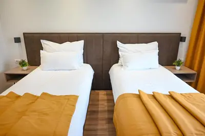 two beds sitting next to each other in a room at Hotel Premium in Jajce