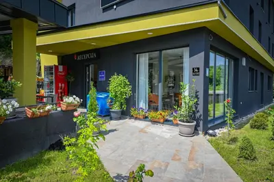 a store front with potted plants in front of it at Hotel Premium in Jajce