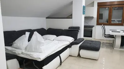 a living room with a bed and a kitchen at Apartmani Kuprešak in Banja Vrućica