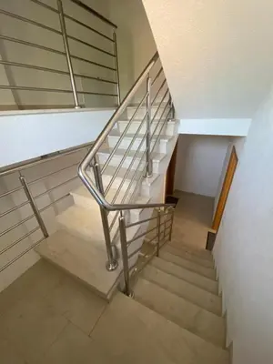 a set of stairs with a metal railing at Apartmani Kuprešak in Banja Vrućica