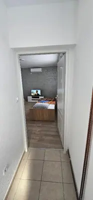 a bedroom with a bed in a room at Apartmani Roki in Tuzla