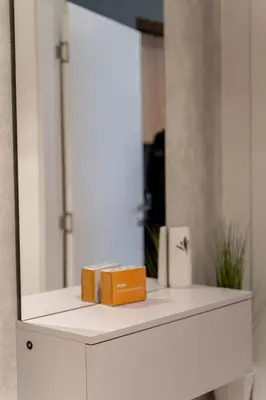 a mirror on top of a white cabinet at Apartman SLOL in Banja Luka