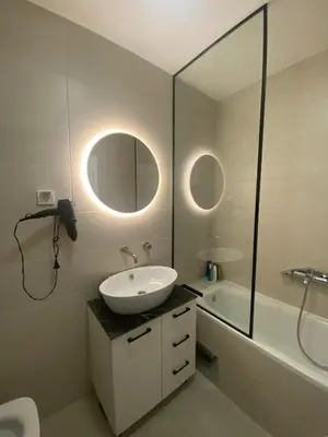 a bathroom with a sink and a mirror and a tub at Apartman SLOL in Banja Luka