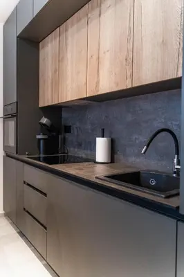 a kitchen with a sink and wooden cabinets at Apartman SLOL in Banja Luka