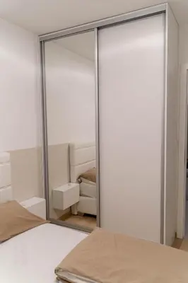 a mirror in a bedroom with a bed at Apartman SLOL in Banja Luka