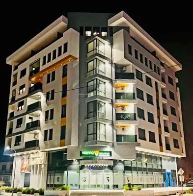 a large apartment building with lights on at Apartment HOLIDAY in Banja Luka