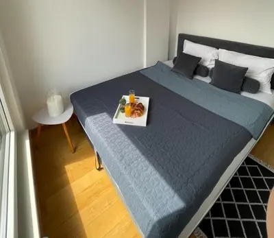a bed with a tray of food on top of it at Apartment HOLIDAY in Banja Luka
