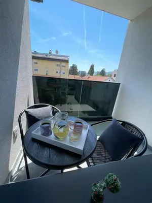 a tray of food on a table on a balcony at Apartment HOLIDAY in Banja Luka