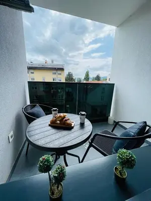 a table and chairs on a balcony with a table at Apartment HOLIDAY in Banja Luka