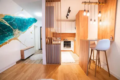 a kitchen with a bar and a dining area in a house at Apartment Vila Idila in Tuzla