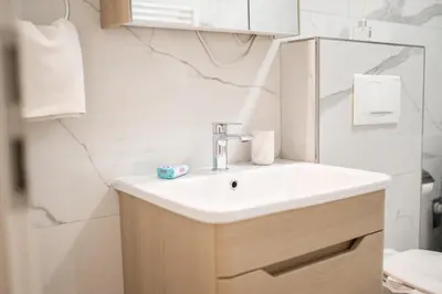 a bathroom with a sink and a mirror at Apartment Vila Idila in Tuzla