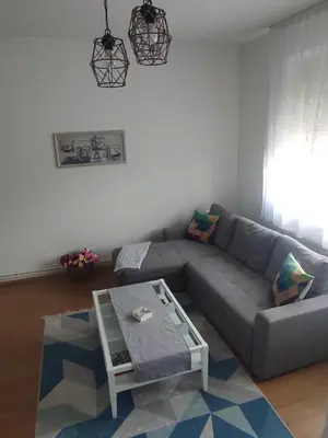 a living room with a couch and a table at Welcome Apartman in Tuzla