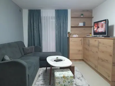 a living room with a couch and a table at Apartmani BET Gradačac 1 Maj broj 24 in Gradačac