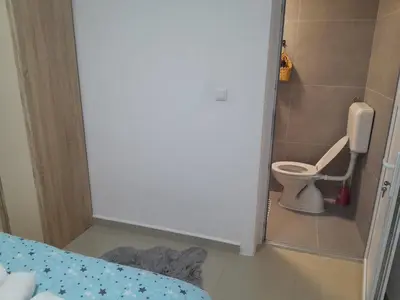 a small bathroom with a toilet in a room at Apartmani BET Gradačac 1 Maj broj 24 in Gradačac