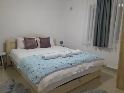 a bedroom with a bed with two towels on it at Apartmani BET Gradačac 1 Maj broj 24 in Gradačac