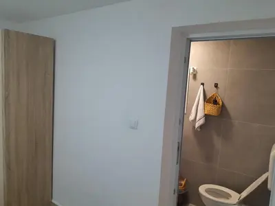 a bathroom with a white toilet and a shower at Apartmani BET Gradačac 1 Maj broj 24 in Gradačac