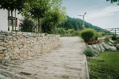 a stone retaining wall next to a stone path at Apartments MoonRiver in Bihać