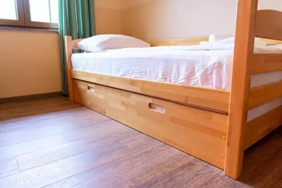 a bedroom with a bunk bed and a wooden floor at Apartments MoonRiver in Bihać