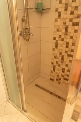 a shower with a glass door in a bathroom at Apartments MoonRiver in Bihać