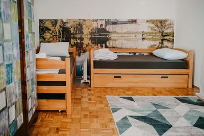 a room with two bunk beds and a rug at Vidovo Domacinstvo in Banja Luka