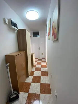 a hallway with a checkerboard floor in a room at Apartman Citylux in Bihać