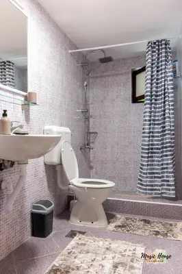 a bathroom with a toilet and a sink and a shower at Music House Apartment in Tuzla