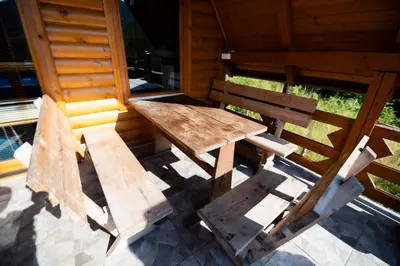 a wooden table and two benches sitting in a cabin at Peace of mind in Visoko