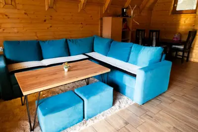 a blue couch and a wooden table in a room at Peace of mind in Visoko