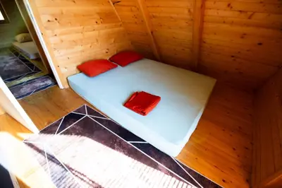 a small sauna with two red pillows on it at Peace of mind in Visoko