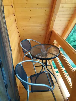 a table and two chairs in the attic of a cabin at Peace of mind in Visoko