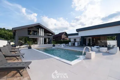 a villa with a swimming pool and a house at Villa Mermaid of Una in Bihać