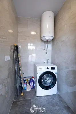 a laundry room with a washing machine in a room at Villa Mermaid of Una in Bihać