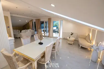 a living room with a white table and chairs at Villa Mermaid of Una in Bihać