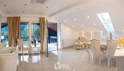 a dining room with a table and chairs at Villa Mermaid of Una in Bihać