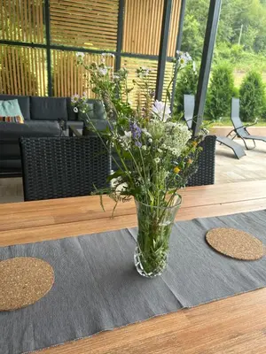 a vase of flowers sitting on a table at Soko holiday home Bihac in Bihać