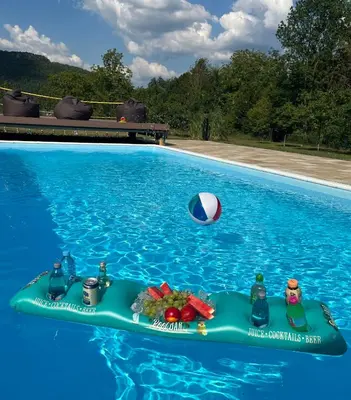 a pool float and a beach ball in a swimming pool at Soko holiday home Bihac in Bihać