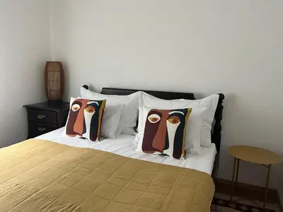 a bed with three pillows with penguins on it at Soko holiday home Bihac in Bihać
