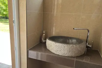 a stone tub sitting on a counter in a bathroom at Soko holiday home Bihac in Bihać