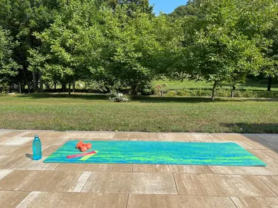 a blue yoga mat with a red flower on it at Soko holiday home Bihac in Bihać