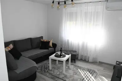 a living room with a couch and a table at Apartment Sarajlic in Prijedor