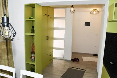 a room with a green cabinet and a hallway at Apartment Sarajlic in Prijedor