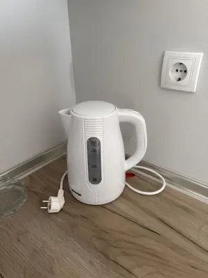 a white blender sitting on the floor in a room at XL Apartman in Teslić