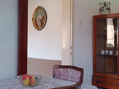 a dining room table with a bowl of fruit on it at Apartmani Emir in Visoko
