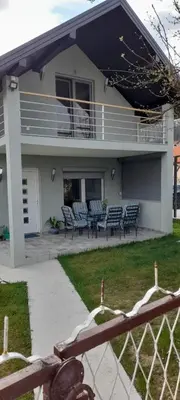 a house with benches in front of it at Ravne weekend house in Visoko