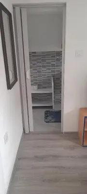 an empty hallway with a room with a heater at Ravne weekend house in Visoko