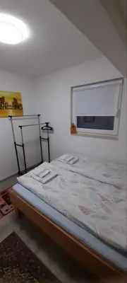 a bedroom with a large bed with a window at Ravne weekend house in Visoko