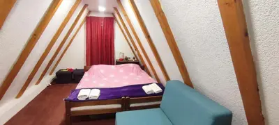 a small bedroom with a bed and a chair at Positive energy in Visoko