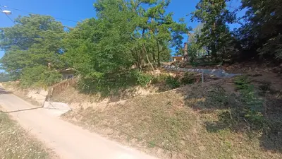 a dirt road with trees on the side of a hill at Positive energy in Visoko