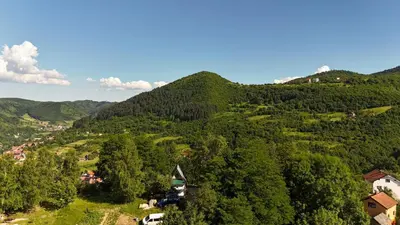 a view of a mountain with houses and trees at Positive energy in Visoko