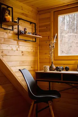 a black chair sitting at a desk in a cabin at Brvnaria in Slatina Varoš